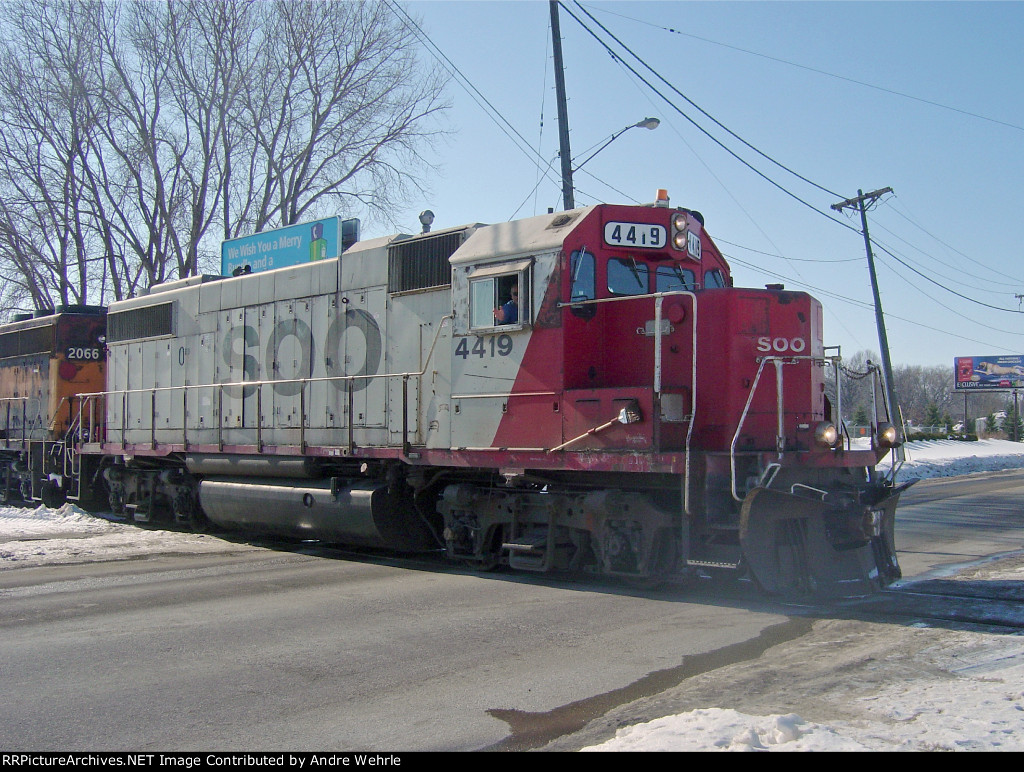 The engineer returns my wave as he crosses Commercial Avenue